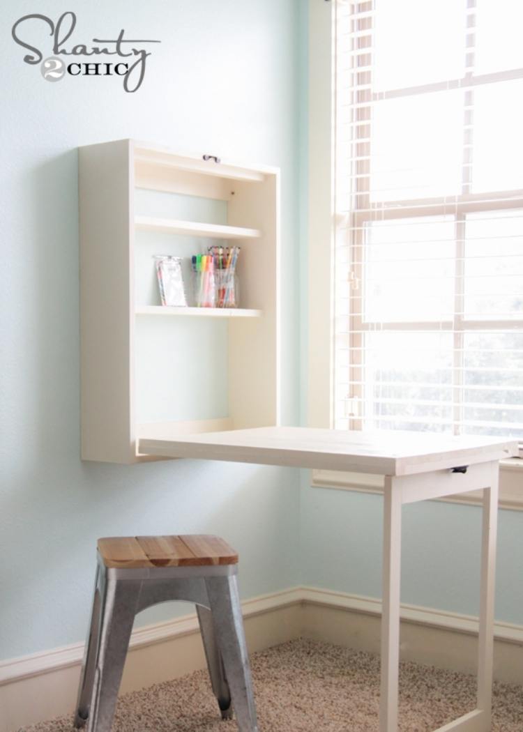 Pull out white murphy desk with bar stool. This desk stows away perfectly to give you more space in small offices when needed.