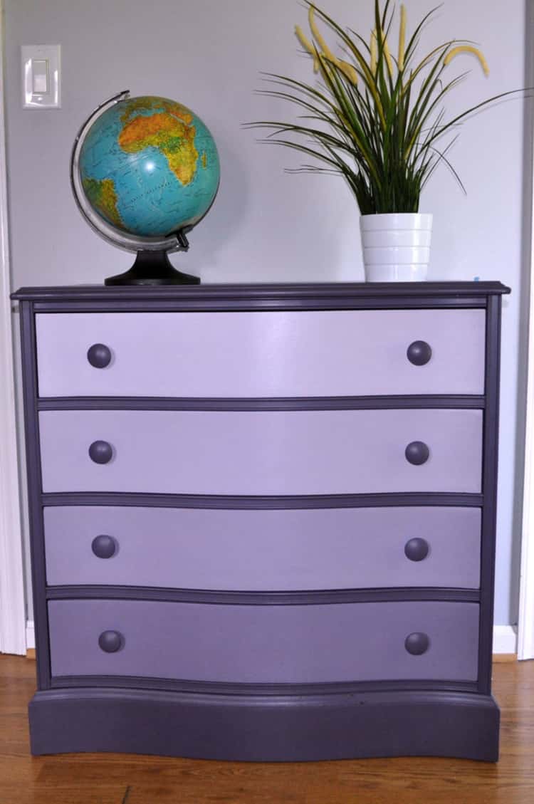 purple ombre dresser with globe and potted plant on top of it.