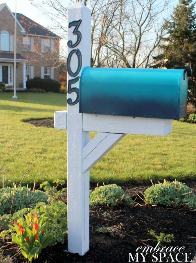 blue ombre mailbox on a white mailbox post