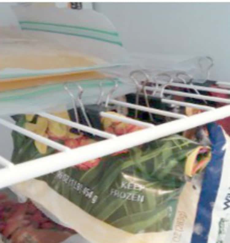 Organize Your fridge by hanging bags of food using clips