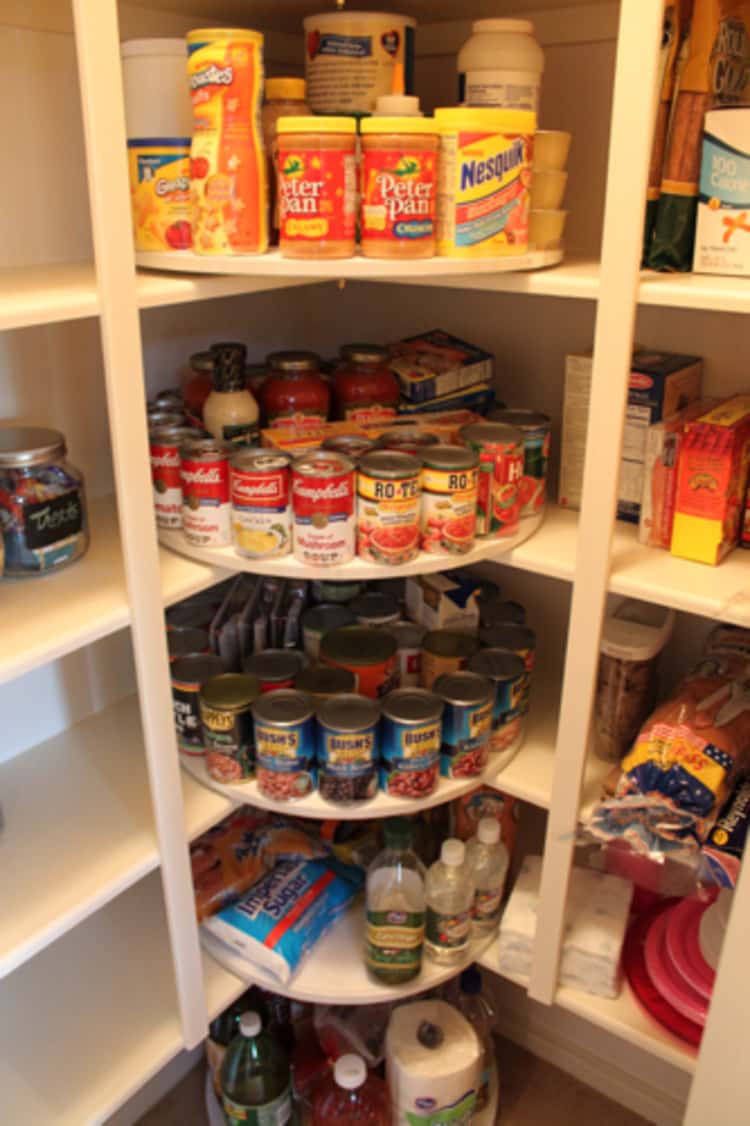 diy lazy susan in the corner of the pantry holding canned goods