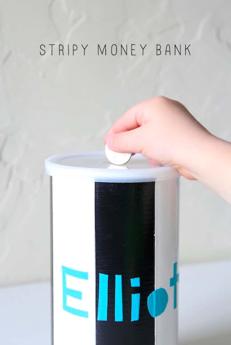 empty oatmeal canister covered in black and white duct tape to look pretty with a slot cut in the top and used for a bank for kids