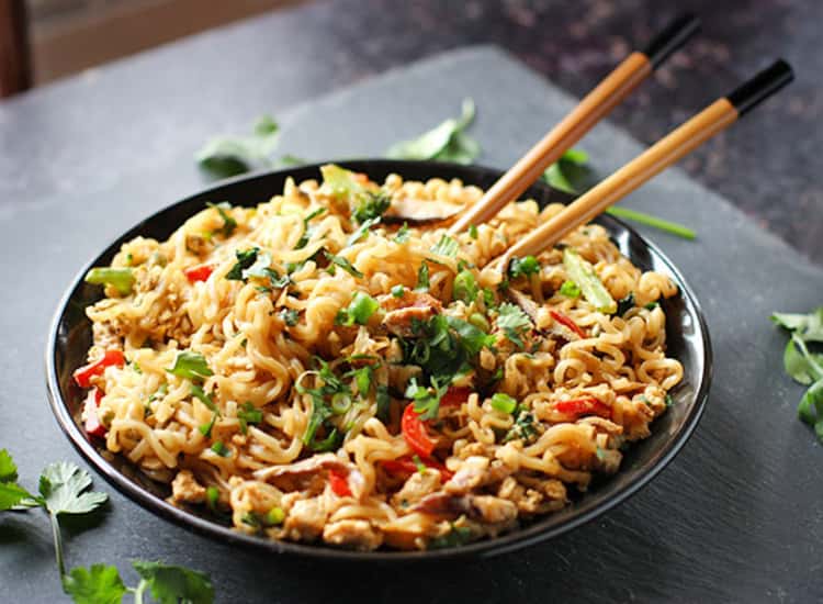 A bowl of Stir fried Ramen Noodles with chopsticks