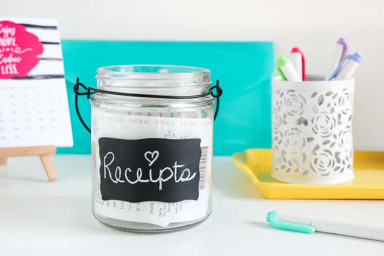 Receipts jar (with label on the front), on a desk to hold receipts so they don't pile up on counters