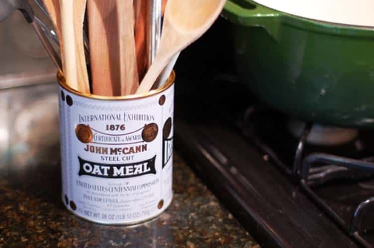 empty oatmeal tin holding kitchen utensils for cooking