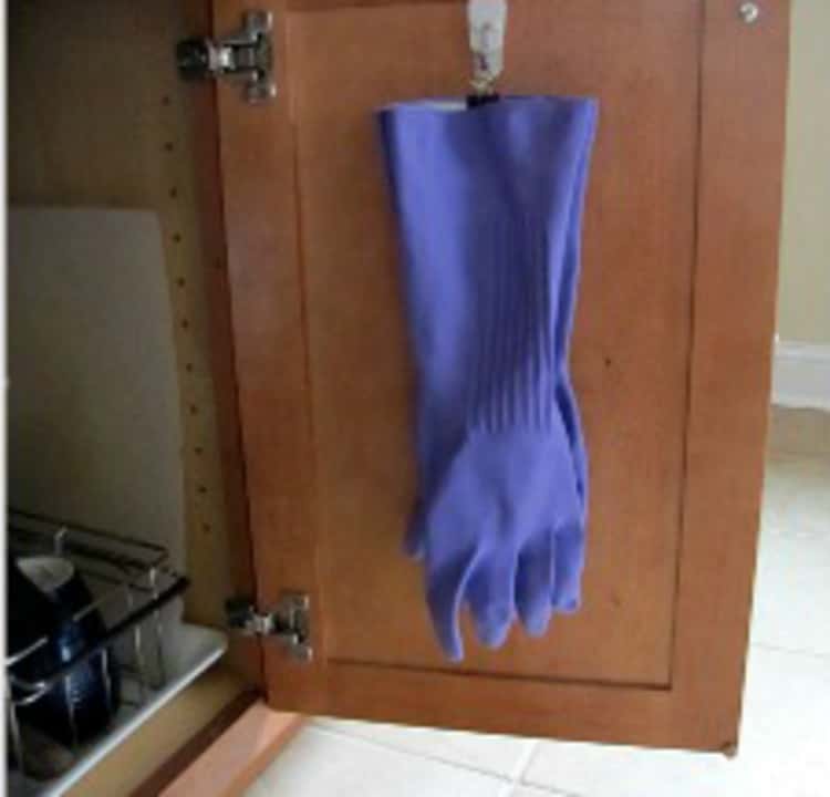 Hang rubber gloves in the closet using file binder clips