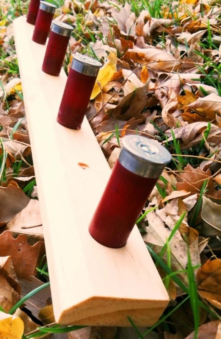 coat rack made from empty shotgun cartridges attached to a plank of wood