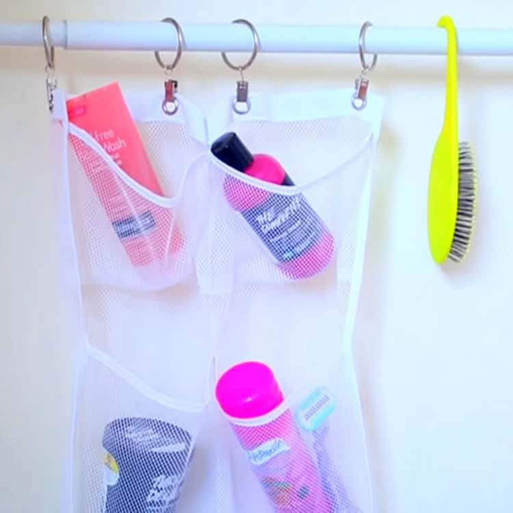 shower hacks - shower products organized with a mesh shoe organizer that's hung on a shower rod