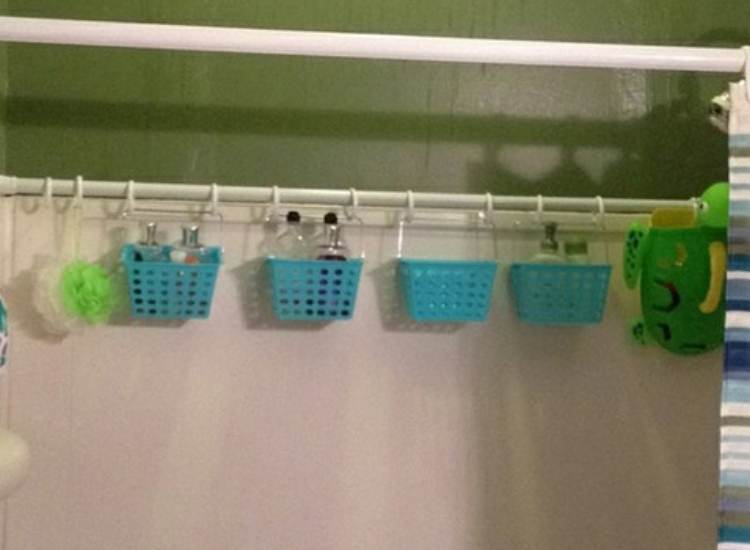 Small blue baskets hanging on a curtain rod to create more space for small bathrooms in tiny apartments. 