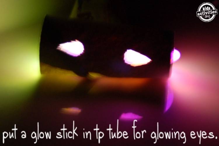 glow stick activities - image of a toilet paper tube with eyes cut out and a glow stick used inside to create the illusion of glowing eyes; the words "put a glow stick in tp tube for glowing eyes."