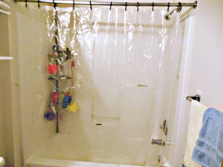 stain removal - bath tub enclosed with a clear shower curtain 