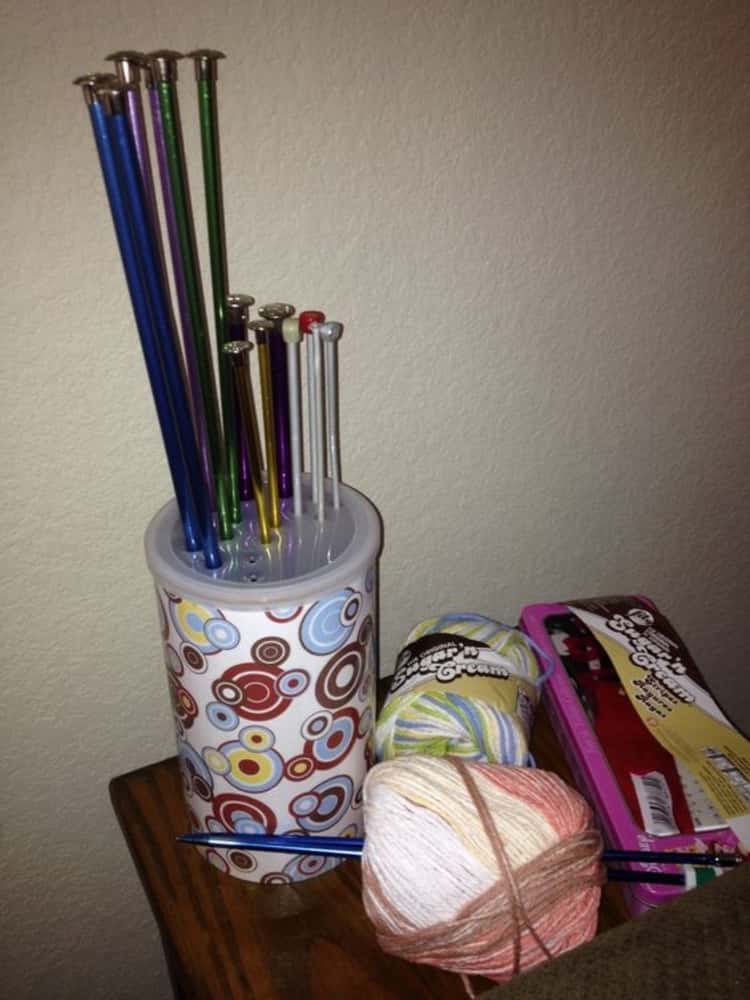 decorated oatmeal canister used to store knitting needles