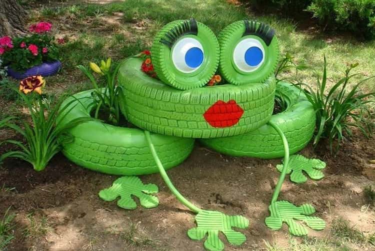 Green frog tire sculpture in the garden