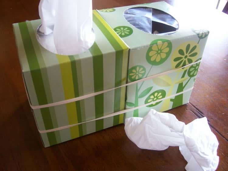 instant mobile trash can made by attaching an empty tissue box and a box of tissue together using rubber bands. 