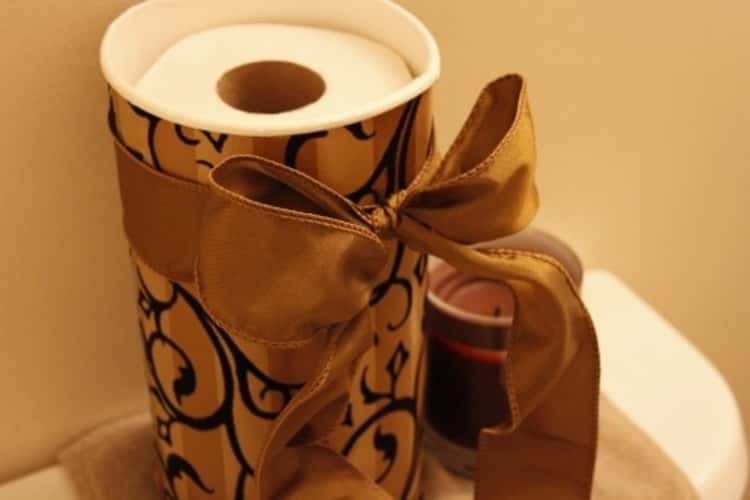 decorated empty oatmeal container turned into a toilet paper holder