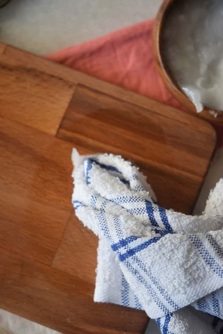dish towel sitting on wooden cutting board