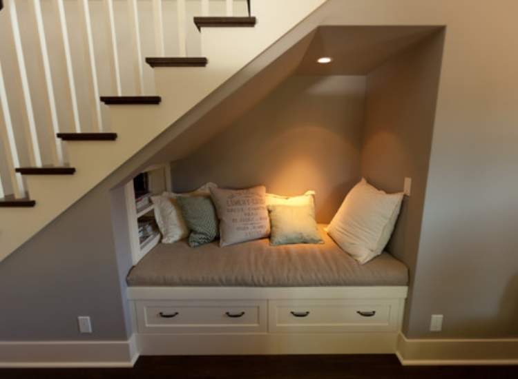 under the stairs reading nook with pillows. Great repurposing idea for tiny rooms. 