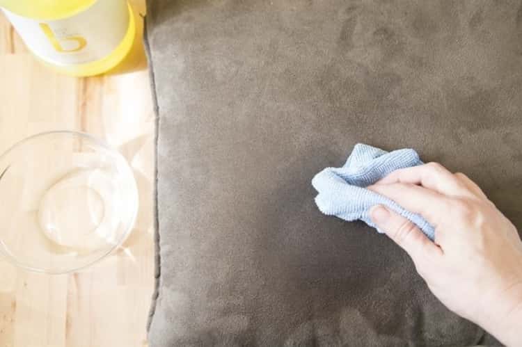 upholstery tips - person wiping a stained spot with cloth