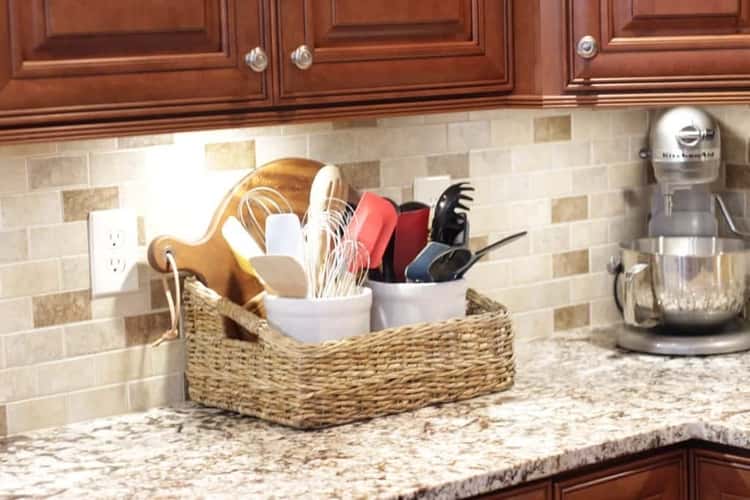 storing utensils upright in a basket on the kitchen counter