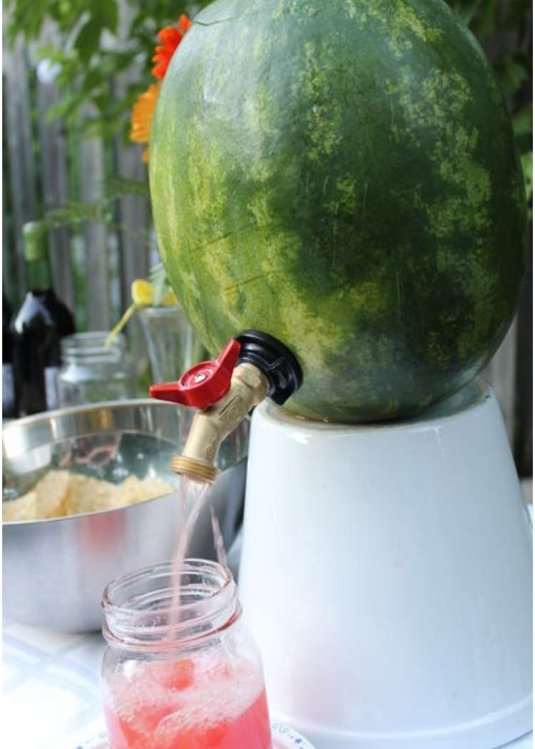 Fun cookout hack- watermelon with a drink tap pouring out pink drink