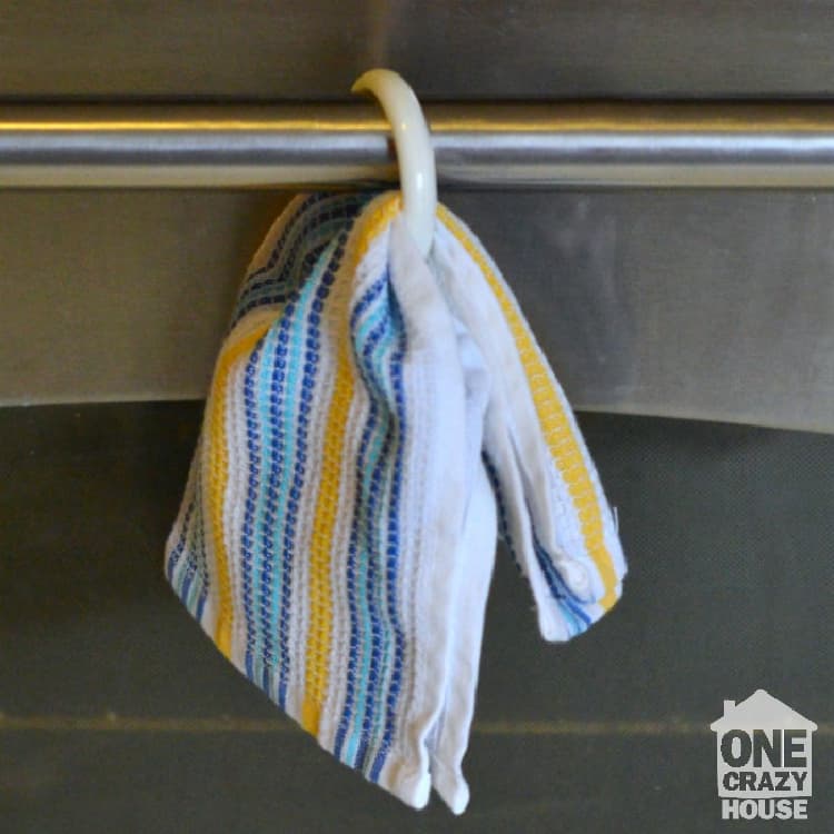 towel hanging on a washing machine rod