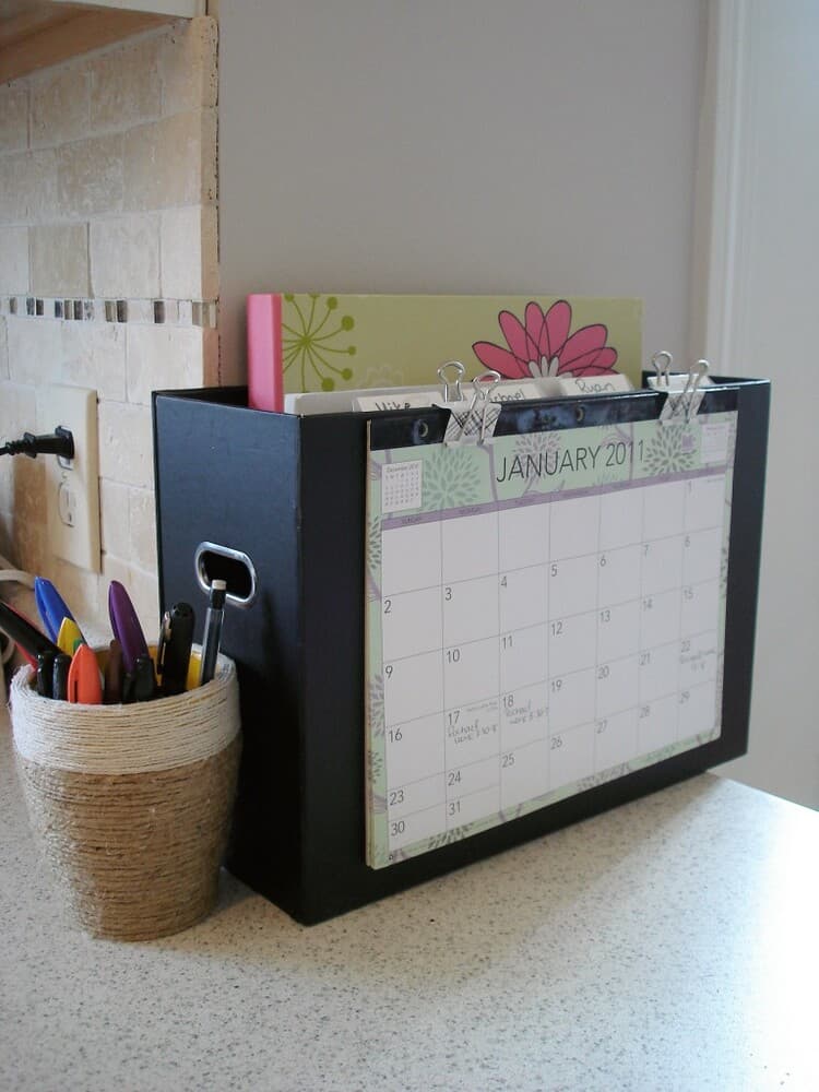 simple command center from a folder to organize papers and notebooks with a callendar clipped on the front