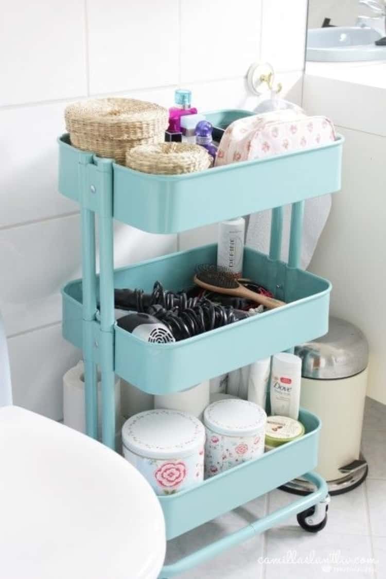 cute portable rolling cart in bathroom to store toilet paper rolls and toileteries, and towels