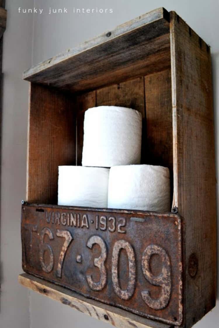 funky toilet paper holder in bathroom using an old wooden crate and vintage license plate