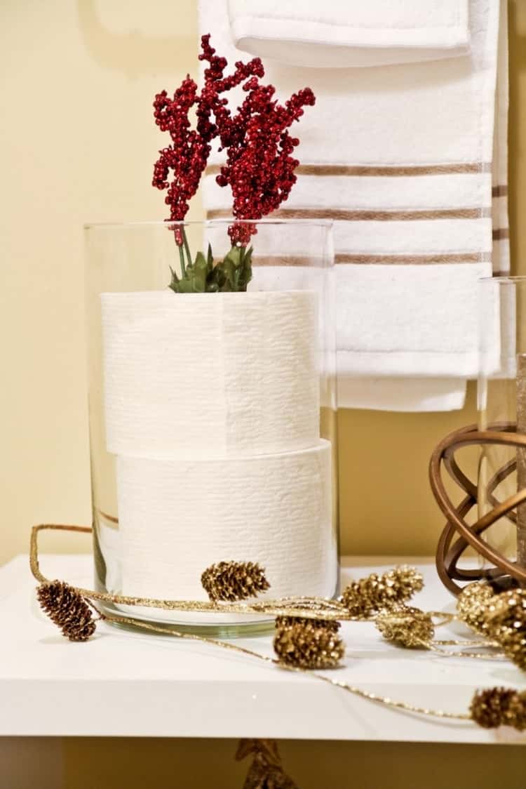 toilet paper storage in bathroom using hurricane vase, decorated for holidays