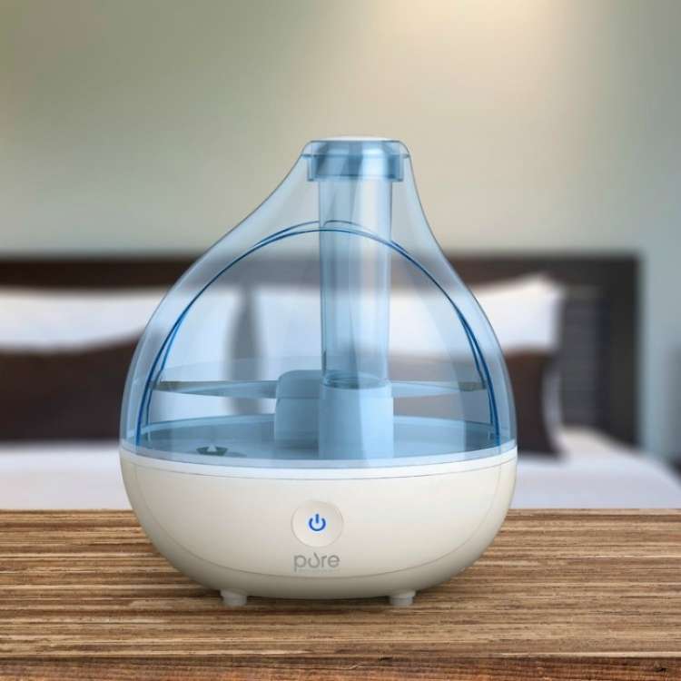 himidifier on top of a wooden table in the bedroom 