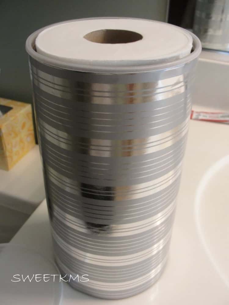 frugal toilet paper storage in bathroom reusing and recycling old oatmeal cannister and wrapping paper