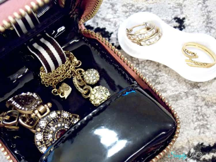 jewelry box and a contact lens case next to it with earrings and ring in them