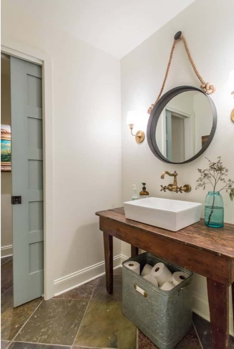 Store bathroom toilet paper in gavanized tub underneath bathroom sink for tidy organization