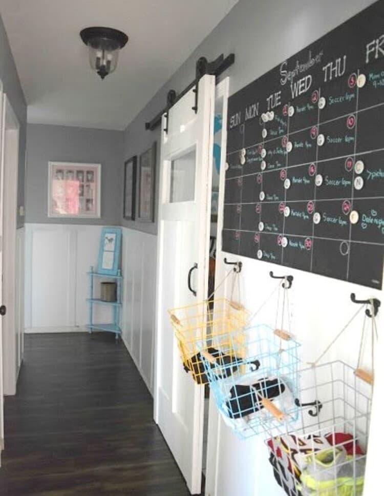 On-Wall Hallway Command Center with a big calendar, wire baskets for storing small items hanging on hoocks under it