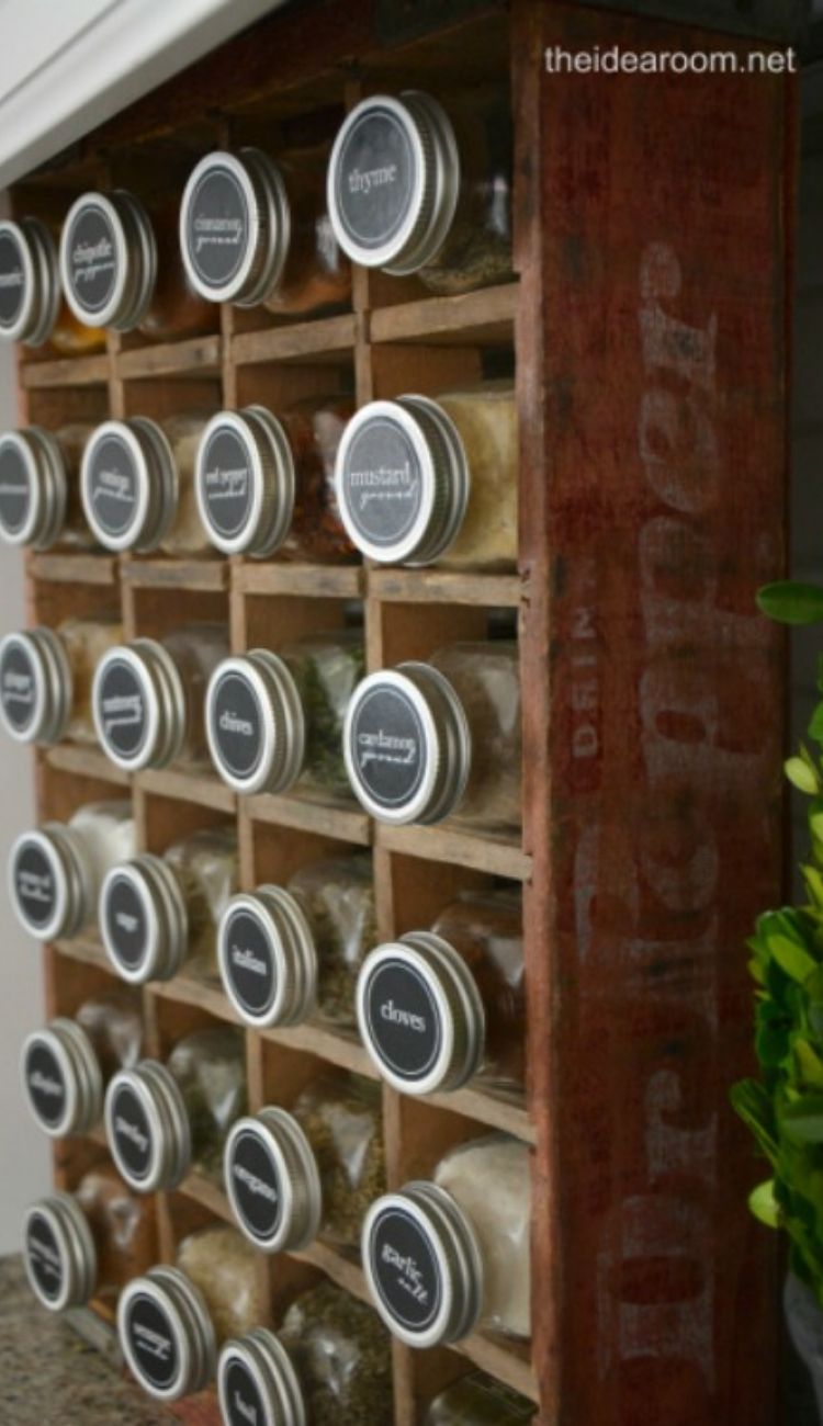 rows of matching spice jars in a wooden shelf