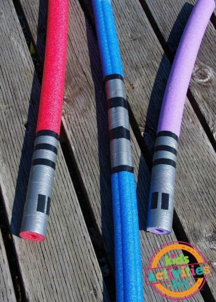 uses for pool noodles- three colorful pool noodles with ends covered with duct tape and electrical tape to create lightsabers