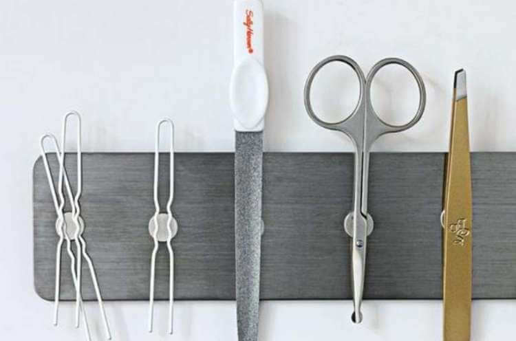 magnetic strip holding bobby pins, nail file, and scissors