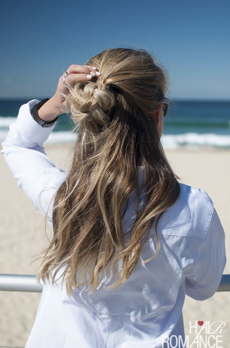 This gorgeous beach hair idea is perfect with it's half up braided knot and half down flowing hair.