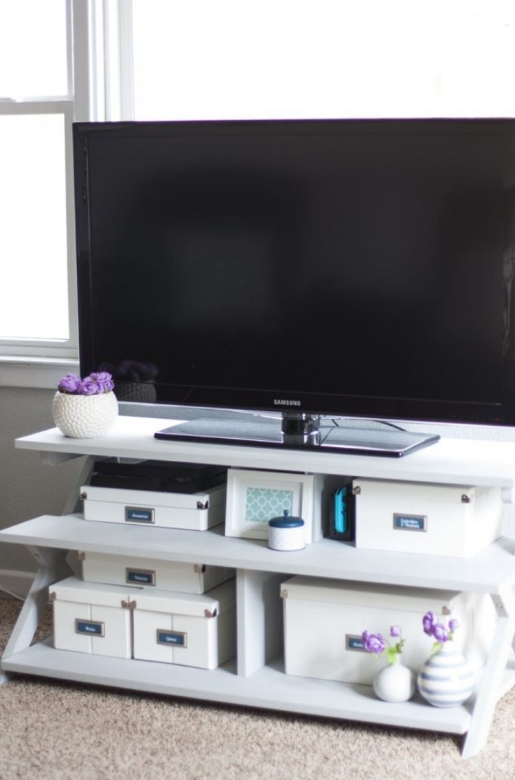 Reuse small storage boxes to declutter under your tv. They make a focal point and serve to declutter. 