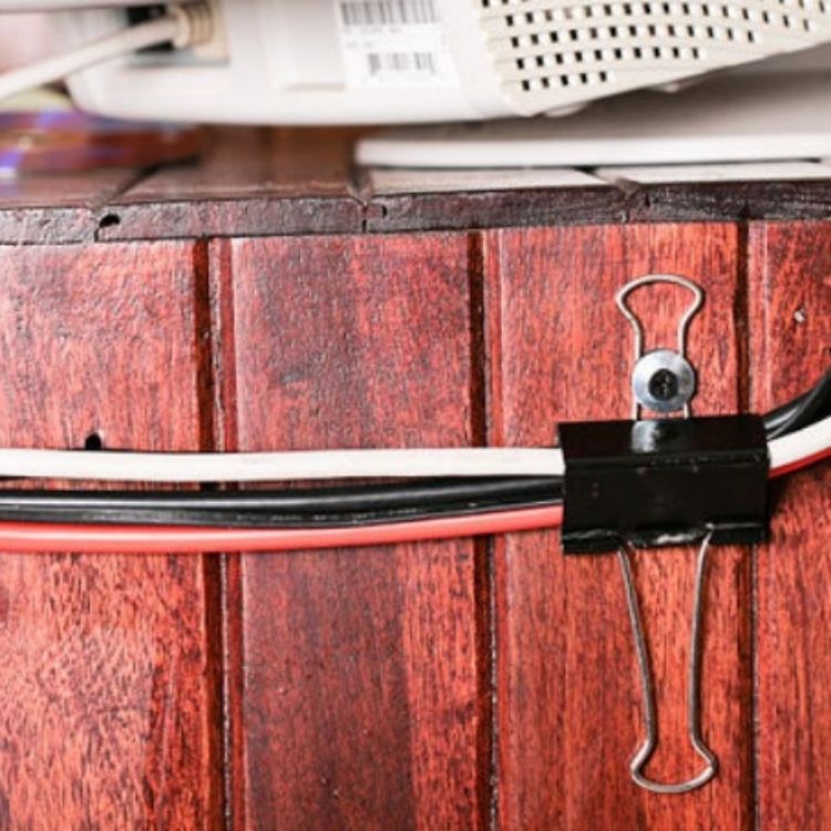 Organize your cords by using a binder clip to hold them down in one spot out of the way along your desk or wall.