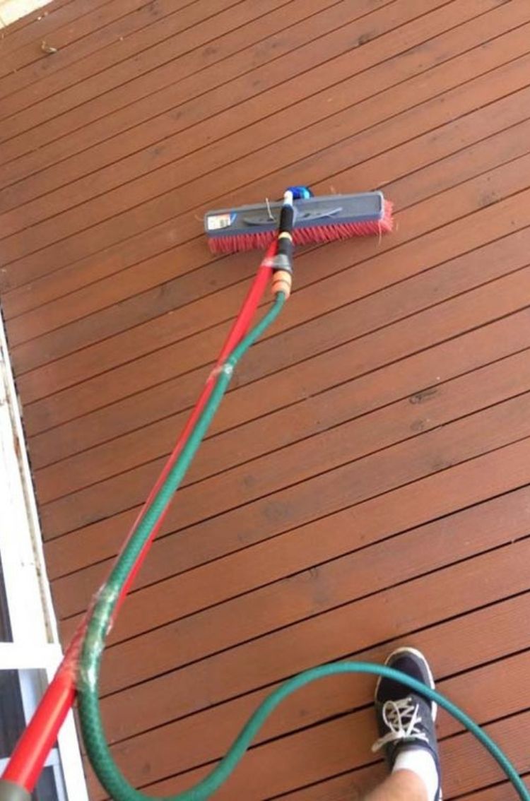 This genius hack is a one of our tock deck ideas. Attach your water hose to the end of a push broom to scrub and wash your deck at the same time. 