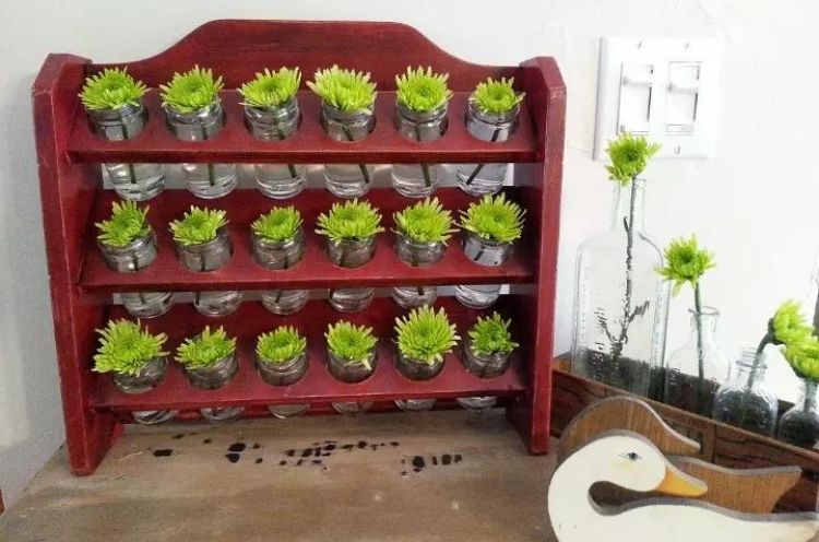 Have a beautiful patch of flowers on your kitchen wall by transforming your old spice rack into a flower vase wall. 