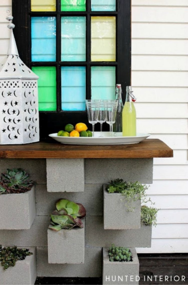 These cinder block planters are amazing, adding not only a creative place to put your patio plants but also a table ledge space. 