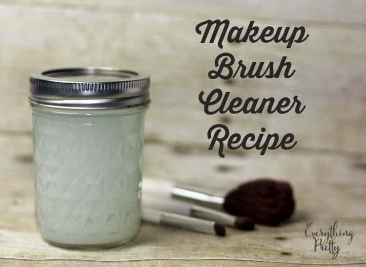 Makeup brushes and a jar full of makeup brush cleaner.