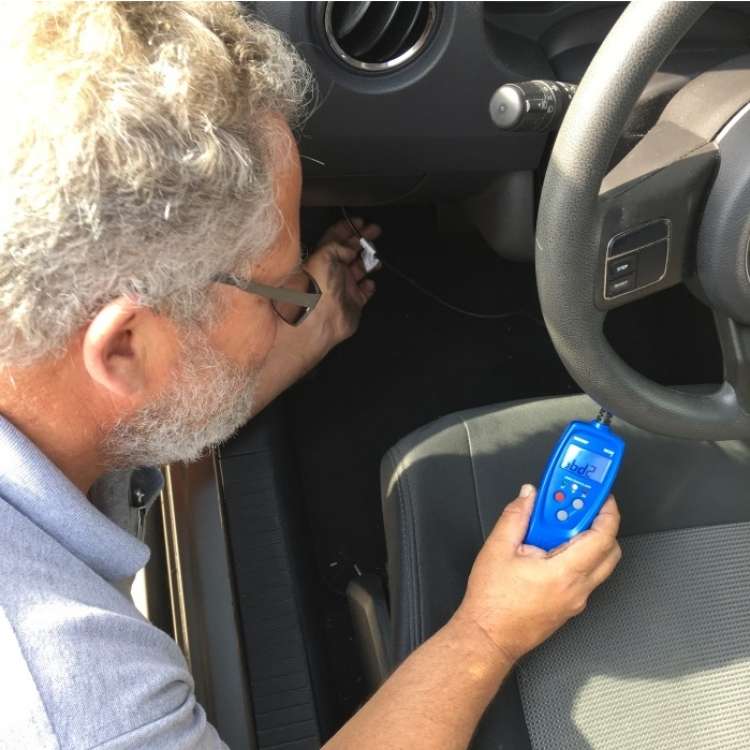 OneCrazyHouse Easy Car Repairs man holding machine inside drivers side of car taking measurement,