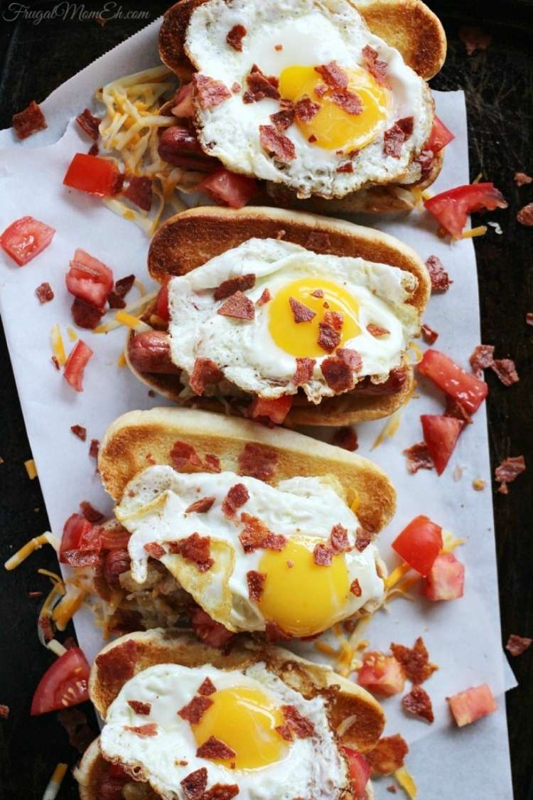 OneCrazyHouse Hot Breakfasts breakfast hotdogs with eggs in buns on tiop of hot dog hashbrowns and chopped bacon