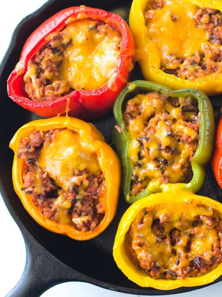 OneCrazyHouse ground turkey recipes cast iron skillet filled with cooked stuffed bell peppers with melted cheese on top
