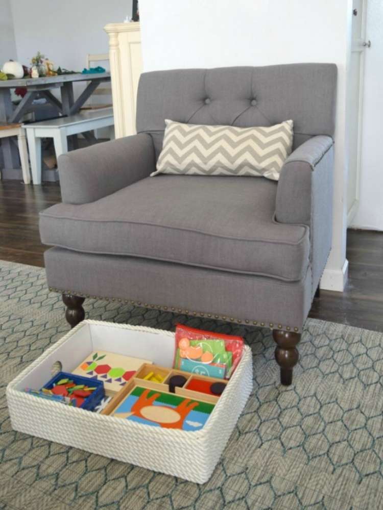 OneCrazyHouse kid friendly living room ideas Bin with toys pulled out from under chair where it's being stored in living room