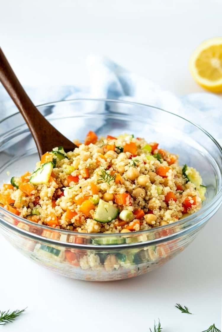 bowl of plant-based meal - quinoa chickpea salad filled with fresh, crisp vegetables, drizzled with a fantastic lemon dill dressing