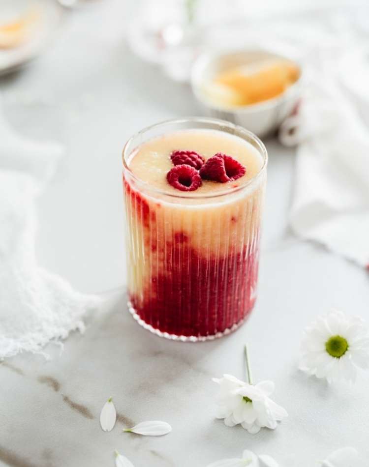 Raspberry Mango Sunrise Smoothie, fresh raspberries, white flowers, fresh fruit smoothie